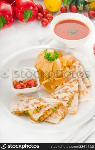 original Mexican quesadilla de pollo with nachos served with gazpacho soup and watermelon ,with fresh vegetables on background,MORE DELICIOUS FOOD ON PORTFOLIO
