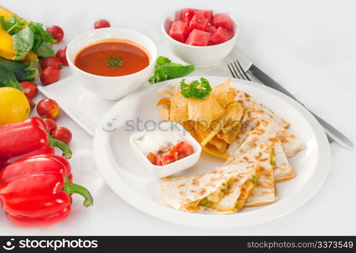 original Mexican quesadilla de pollo with nachos served with gazpacho soup and watermelon ,with fresh vegetables on background,MORE DELICIOUS FOOD ON PORTFOLIO