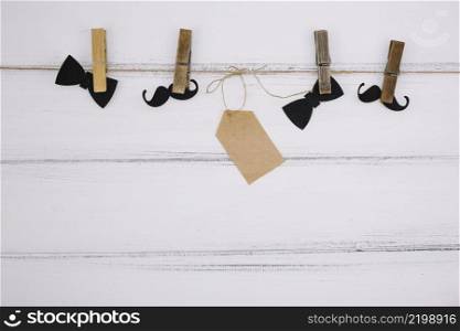 ornament paper bow tie near mustache tag thread