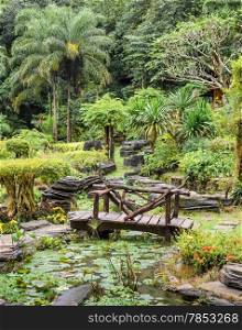 Ornamental garden with foot bridge over a pond