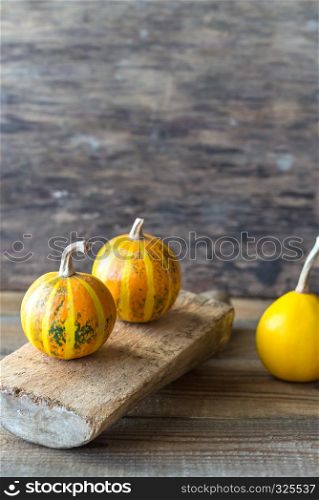 Ornamental pumpkins on the wooden background