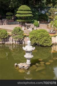 Ornamental Shuzhuang garden and pond with chinese lantern on island of Gulangyu near Xiamen. Ornamental garden on Island of Gulangyu near Xiamen China