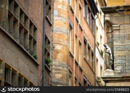 Ornamental Stone Woman Facing Wall of Windows