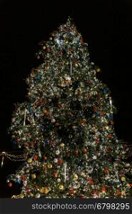 Ornate and lighted Christmas tree outside