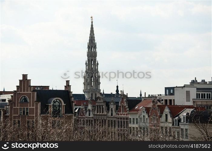 Ornate Brussels Town Hall in Grand Place over old and new buildings