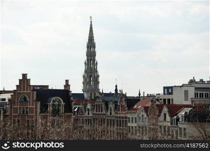 Ornate Brussels Town Hall in Grand Place over old and new buildings