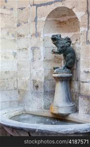 Ornate Brussels Town Hall in Grand Place with detail of water fountain carved with lion statue
