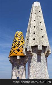 Ornate chimney designs on the roof of Gaudi&rsquo;s Neo-Gothic palace of Palau Guell, just off Las Rambla in the Eixample district of Barcelona in the Catalonia region of Spain.