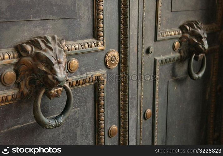 Ornate door knockers on a door, Havana, Cuba