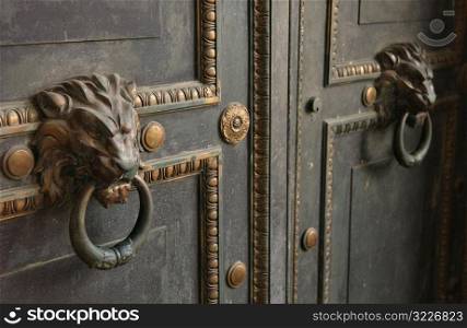 Ornate door knockers on a door, Havana, Cuba