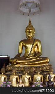 Ornate golden buddha statue in Wat Po temple near Bangkok in Thailand