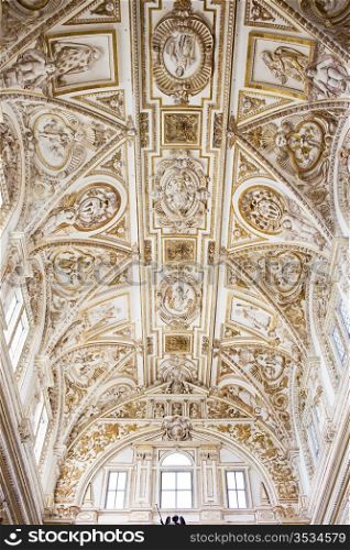 Ornate Italian Renaissance style ceiling of the Mezquita Cathedral interior in Cordoba, Spain.