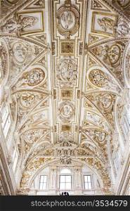 Ornate Italian Renaissance style ceiling of the Mezquita Cathedral interior in Cordoba, Spain.