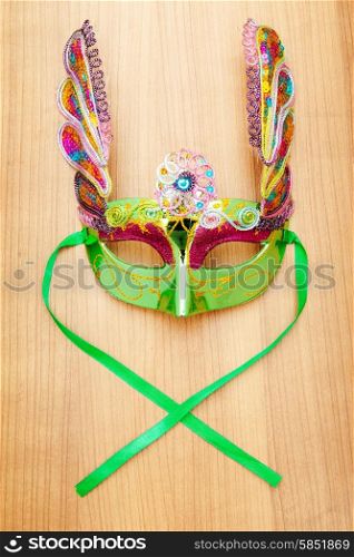 Ornate masks isolated on the wooden background
