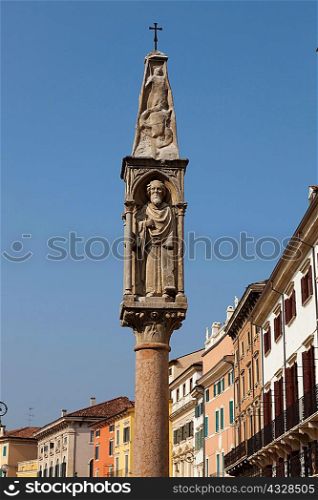 Ornate pillar overlooking city street