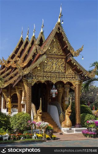 Ornate Thai Architecture - Nagas guard the entrance to Wat Gate Karan Buddhist temple in the city of Chiang Mai in northern Thailand.