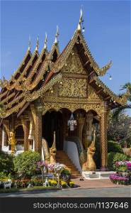 Ornate Thai Architecture - Nagas guard the entrance to Wat Gate Karan Buddhist temple in the city of Chiang Mai in northern Thailand.