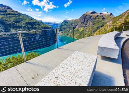 Ornesvingen view point with lookout seat. Geiranger fjord landscape. National Tourist Route in Norway. Ornesvingen viewing point Norway