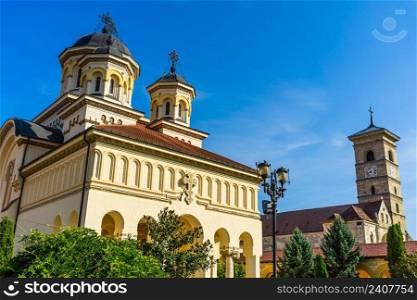 Orthodox and catholic cathedral view on sunny day in Alba Iulia, Romania, 2021