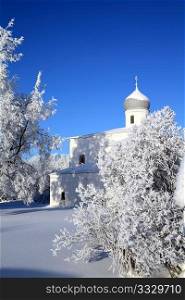 orthodox christian church amongst snow tree