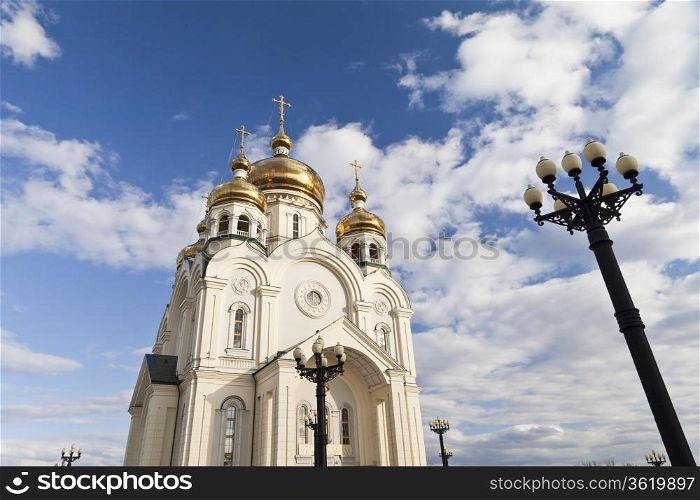 Orthodox church against the blue sky and white clouds