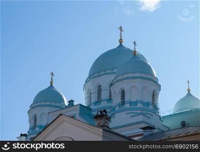 Orthodox Church with swans on the sky background