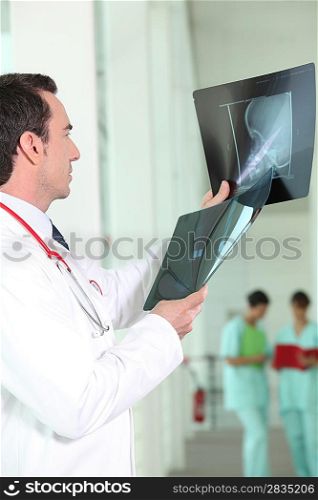 Orthopedic surgeon with two x-rays