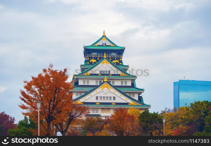 Osaka Castle building with colorful maple leaves or fall foliage in autumn season. Colorful trees, Kyoto City, Kansai, Japan. Architecture landscape background. Famous tourist attraction.