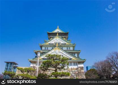 Osaka castle on a clear day the sky bright during sakura blossom time are going to bloom, Japan.
