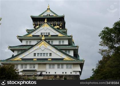Osaka castle . The Osaka castle in Japan in front of a cloudy sky