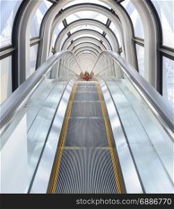 Osaka, Japan - April 08, 2015: View of the spectacular escalator in Umeda Sky Building with tourist, a modern high rise skyscraper in the Kita district of Osaka, Japan