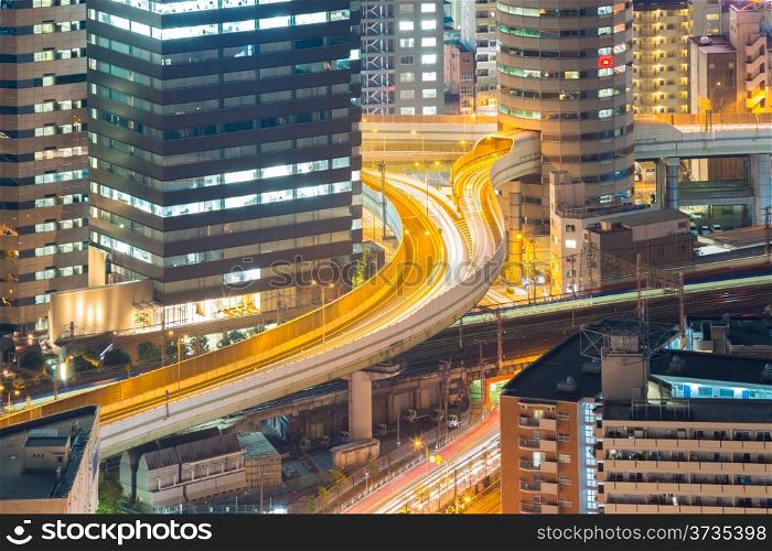 Osaka skyline with highway through its building at night, Japan