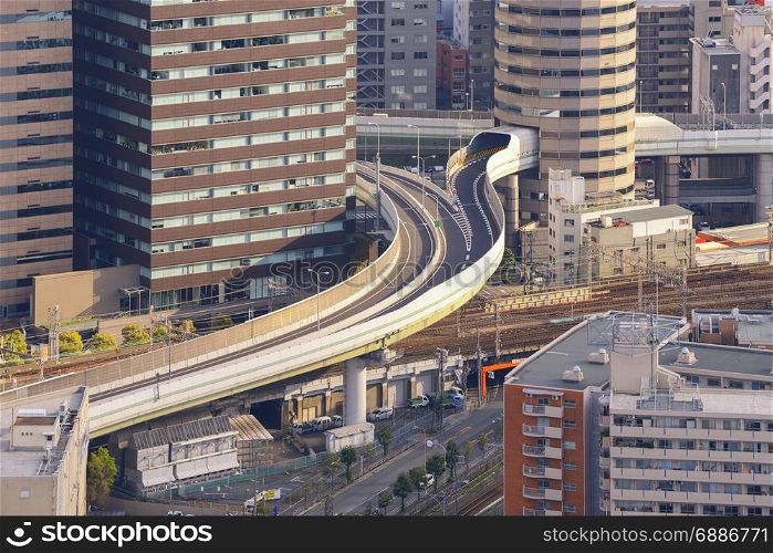 Osaka skyline with highway through its building at sunset, Japan