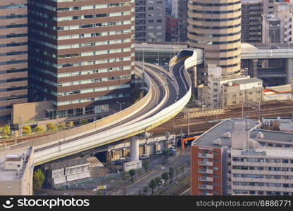 Osaka skyline with highway through its building at sunset, Japan