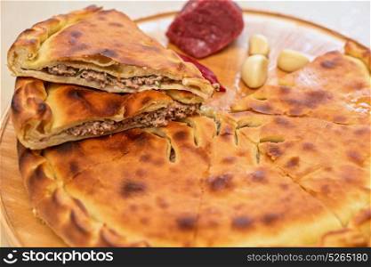 ossetian pie on a white. Meat ossetian pie on a white background