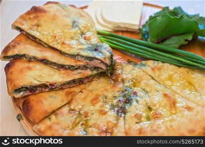 ossetian pie on a white. ossetian pie with beetroot onion and cheese on a white background