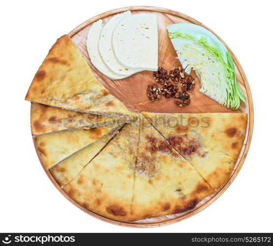 ossetian pie on a white. ossetian pie with cabbage and nuts on a white background