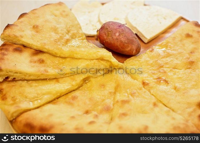 ossetian pie on a white. ossetian pie with potato and cheese on a white background