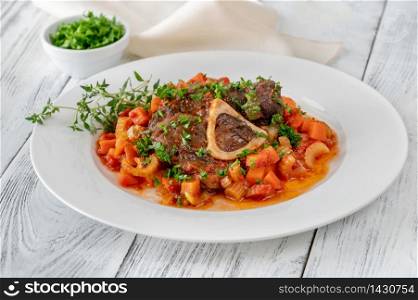 Ossobuco - Italian cuisine specialty with veal shanks and vegetables
