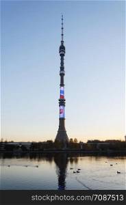 Ostankino Tower in Moscow, Russia. View from the pond at sunset.