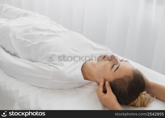 osteopathist treating female patient indoors