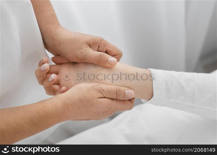 osteopathist treating patient s arms close up