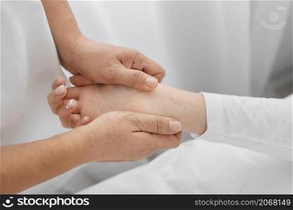 osteopathist treating patient s arms close up