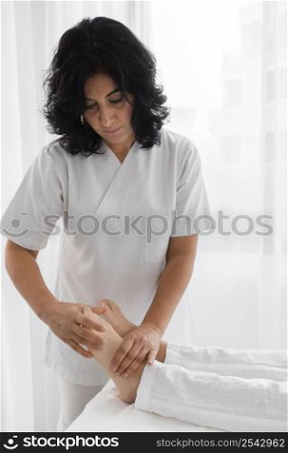 osteopathist treating young woman
