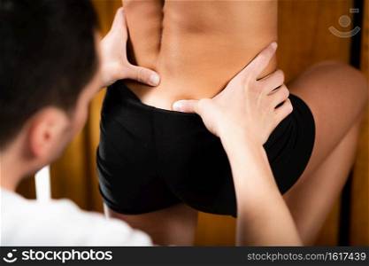 Osteopathist Working with Female Patient. Osteopathy Treatment for Lower Back.