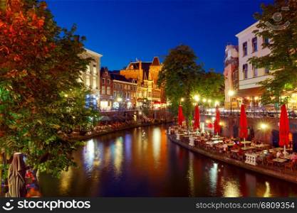 Oudegracht canal in night illumination at sunset. Utrecht. Netherlands.