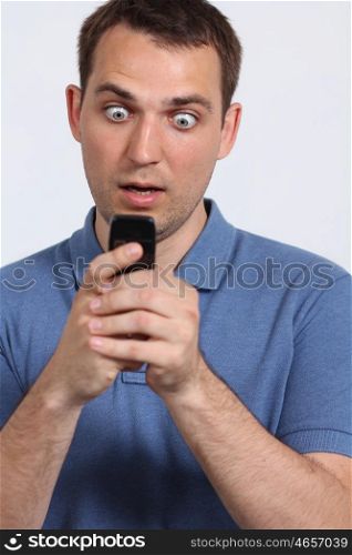 oung guy sending a sms with his mobile phone