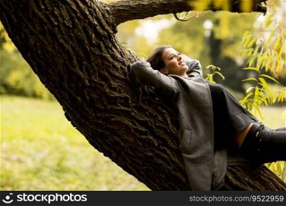 oung woman resting on the tree