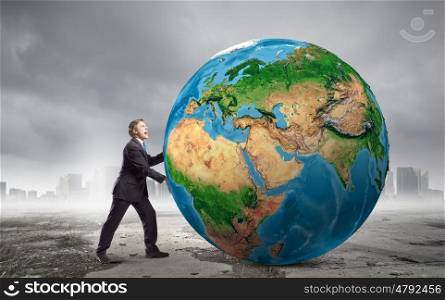 Our Earth planet. Businessman pushing big Earth planet. Elements of this image are furnished by NASA