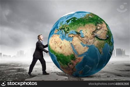 Our Earth planet. Businessman pushing big Earth planet. Elements of this image are furnished by NASA